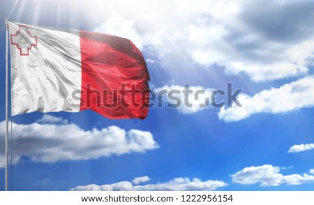 Flag of malta on a flagpole against a blue sky, with a good place for your text.