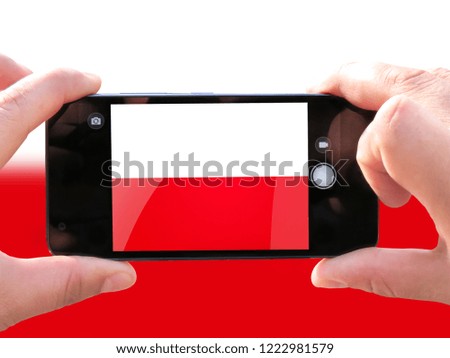 The concept of tourism and travel. The hands of men make a telephone photograph of the flag of Poland. On the smartphone close-up image of the flag. Photos for social networks, blogs, instagram.