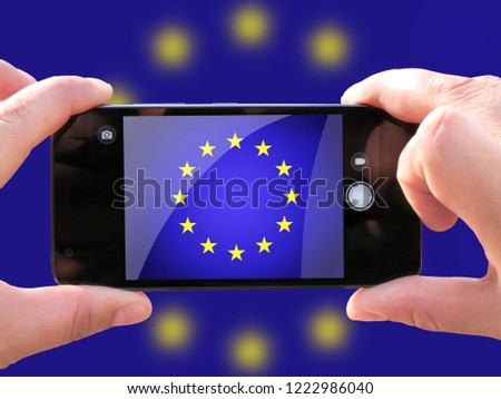 The concept of tourism and travel. The hands of men make a telephone photograph of the flag of European Union. On the smartphone close-up image of the flag. Photos for social networks, blogs