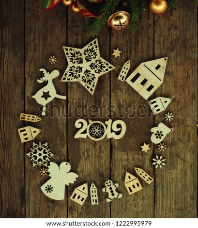 christmas and new year card with tree decorations/wooden figures of houses,snowflakes on the  rustic background
