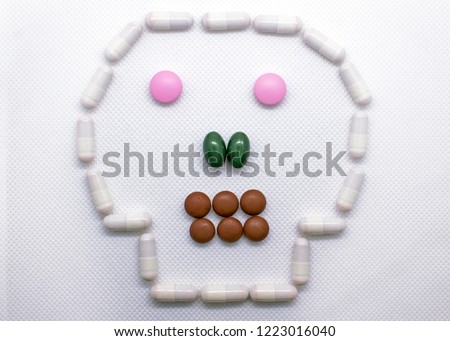 The concept of health care, medical devices, treatment of diseases, the benefits and harm of tablets. form of the skull paved with pills on a white background.