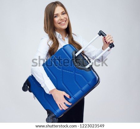 Happy woman hold travel suitcase. Portrait of young businesswoman with positive emotion.