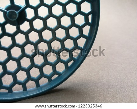Sectoral fragment of plastic grid with hexagonal pattern resembling organic molecular structure. Abstract photo on the subject of science / chemistry, medicine or chemical industry.