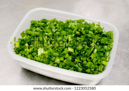 chopped green onions in  Plastic food containers
