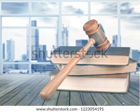 Books and wooden gavel on table. Justice concept