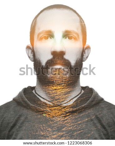 Double exposure portrait of young bearded man and sunset.
