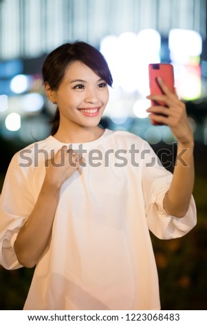 woman use smart phone selfie happily at night