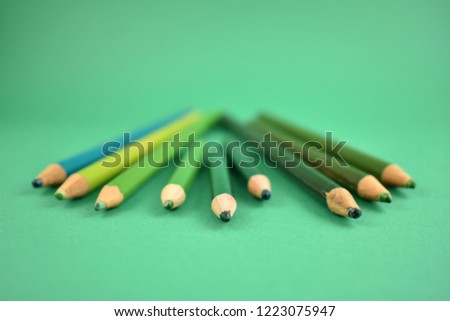 Green crayons stock images. Set of green crayons on a green background. Art supplies images