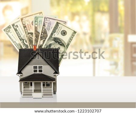 Dollar bills and house model isolated