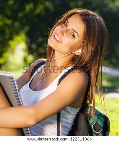 Happy young student outdoors in sunny day