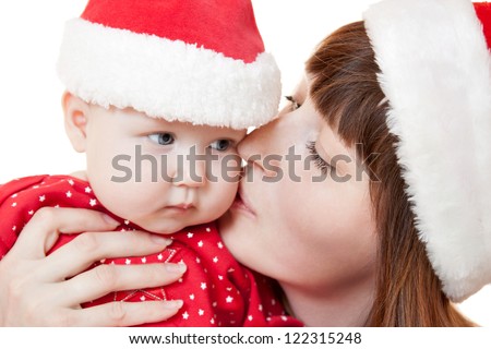 Mother kissing her child and celebrate Christmas