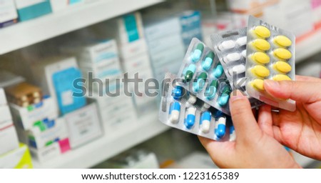 Hand holding medicine capsule pack at the pharmacy drugstore.copy space Royalty-Free Stock Photo #1223165389