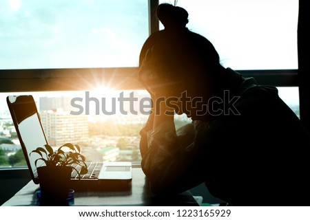 woman sitting down, his face unsettled. At the computer desk she has headaches and stress. Cause of hard work and insufficient rest. Royalty-Free Stock Photo #1223165929