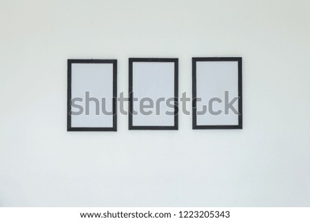 Empty frame on white wall