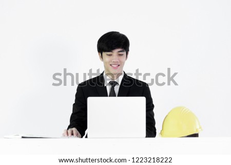 Asian manager businessman sitting at desk and working with laptop, isolated on white background.