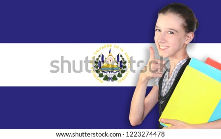 Happy young girl holding books, on the background of the flag of El Salvador. The concept of language learning and study. Travels.