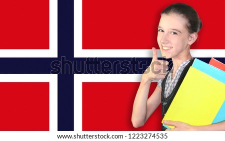 Happy young girl holding books, on the background of the flag of Norway. The concept of language learning and study. Travels.