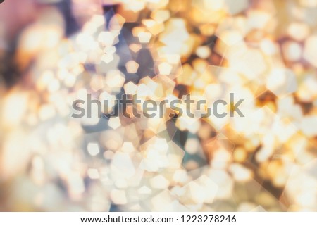 Bokeh light, shimmering blur spot lights on beige abstract background.