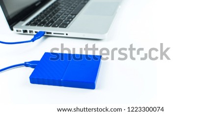 Close up of external hard disk drive for connect to laptop, transfer or backup data between computer and HDD. Blue hard disc for backup files and important information using USB 3.0 connection