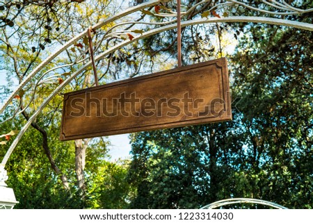 wooden empty signboard at the entrance of the garden