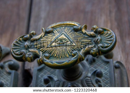 All seeing eye of illuminati on a door knob of the Illuminati freemason in Stockholm, Sweden. Royalty-Free Stock Photo #1223320468