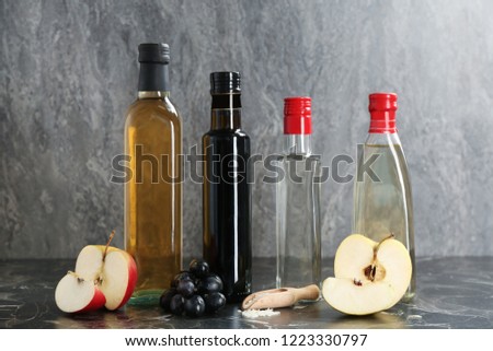 Composition with different kinds of vinegar and ingredients on table Royalty-Free Stock Photo #1223330797