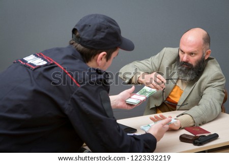 Male businessman being questioned by the police.