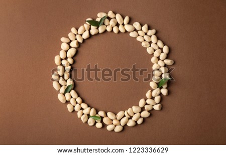 Composition with peanuts and space for text on color background, top view