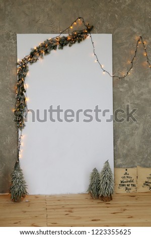 Christmas postcard  and little green trees on a gray wall background