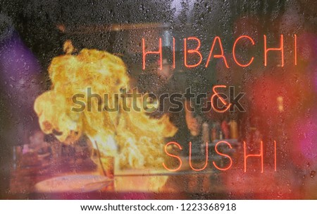 Hibachi and Sushi Neon Sign With Chef in Background, Blur Rainy Window Image