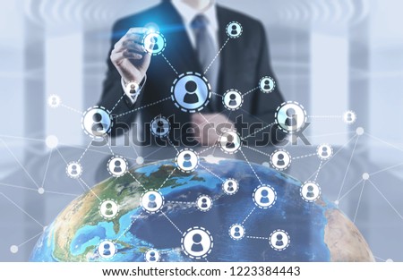 Unrecognizable man in office using Earth hologram and global people network. Toned image double exposure mock up. Elements of this image furnished by NASA