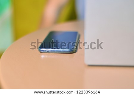 On the wooden table is smartphone, laptop. copy space 