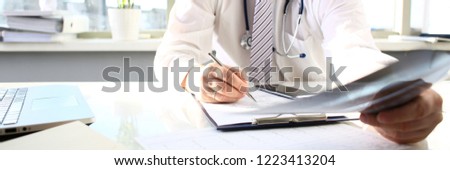 Male doctor hold in arm silver pen and look at xray photography closeup. Skeleton bone disease exam medic aid or cancer physical test in hospital for healthy lifestyle education career concept