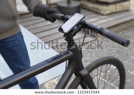 Background of a man ride electric bicycle and use mobile phone to guide a destination, kilometer, and energy.      