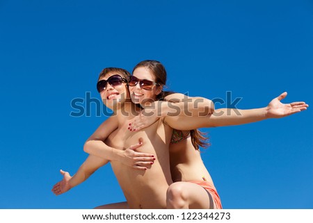 Portrait of a happy young couple enjoying at beach