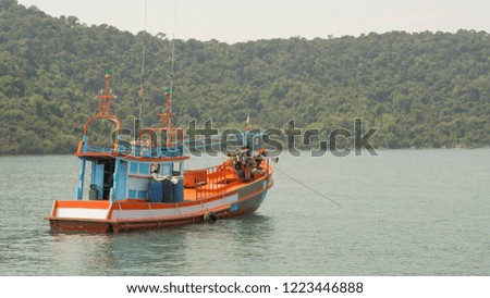 One Thai fishing boat anchored in the sea.