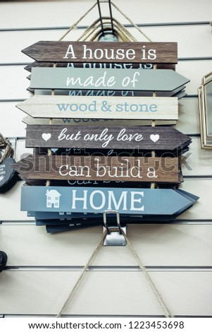 Composition of wooden painted breds with Motivational and inspirational quotes - Only love can build a home on the wall background. Vintage styled toning. Home comfort concept. Selective focus.