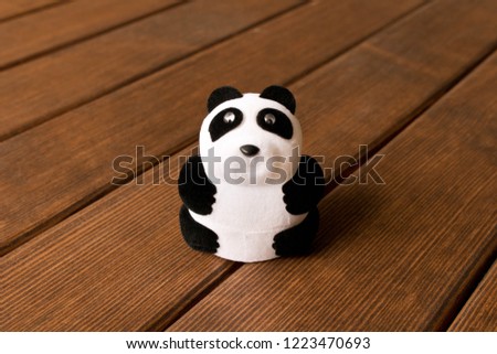 Funny toy Panda on a wooden table