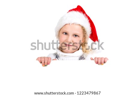 Happy young girl with Santa's hat posing with big board