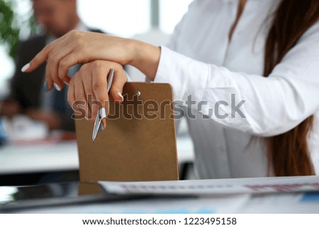 Female arm in suit hold silver pen and pad making note in office closeup. Deal consult delivery signature financial inspector job fill survey form discuss strategy project negotiation concept