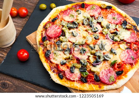 Italian pizza. Delicious fresh baked pizza served on wooden table.