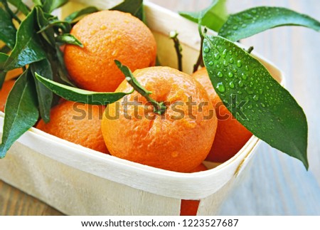 mandarin orange or mandarine in basket for sale in supermaket with wooden floor