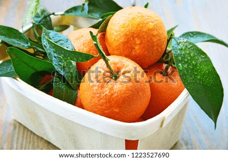 mandarin orange or mandarine in basket for sale in supermaket with wooden floor