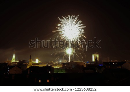 Fireworks above city buildings at night. Happy new year