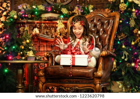 Happy little girl with gift box sitting