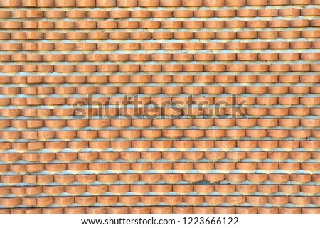 An Old red brick wall in the industrial zone of an abandoned factory. Can be useful as background.