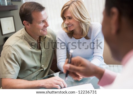 Couple in consultation at IVF clinic talking to doctor