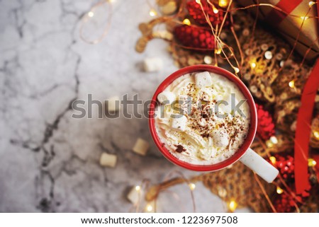 cup of hot cocoa or chocolate with Christmas present on white marble table from above