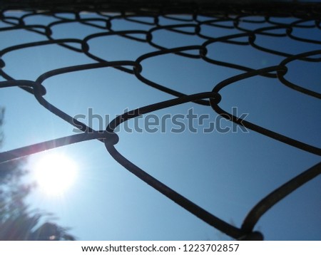 Mesh made of steel to make fences to prevent theft.Take close-up photography and blue sky to the background.