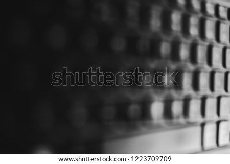 unfocused laptop keyboard background with side perspective